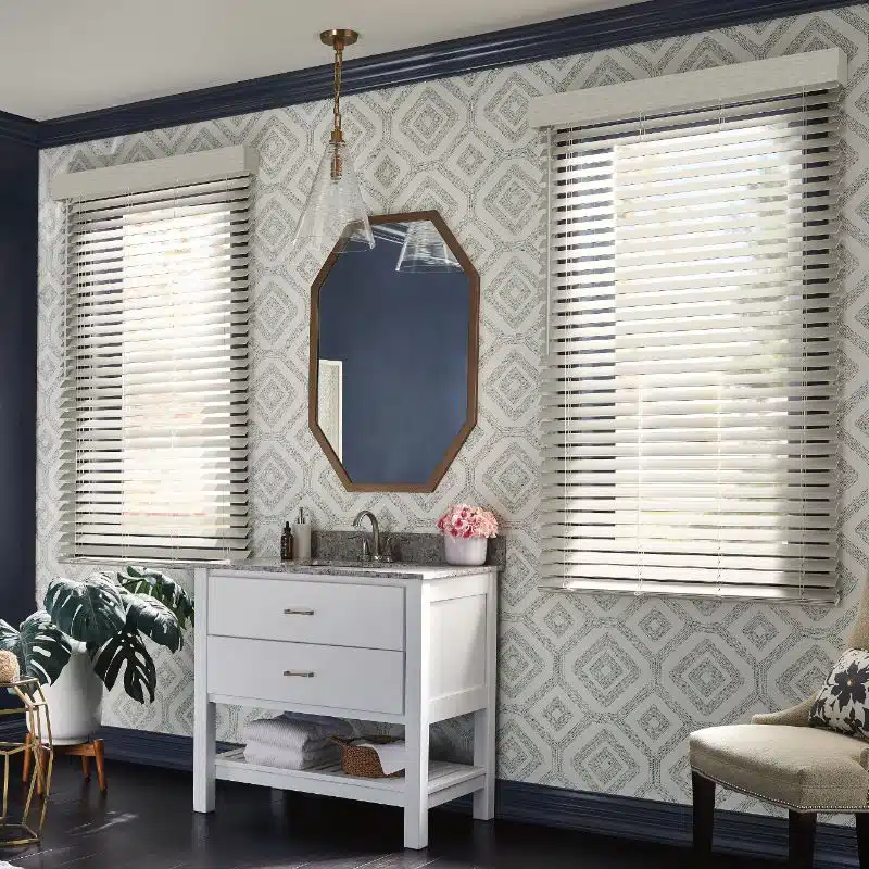 faux wood blinds handing above a dresser