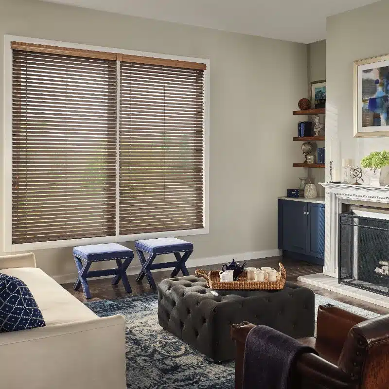 natural wood blinds hanging on windows by a fireplace